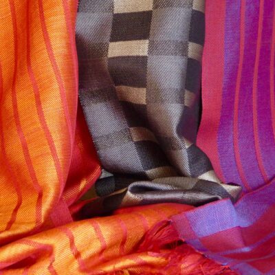 Three silk scarves, reds and a grey. - Handwoven silk. - 30cms x 180cms. - by Geraldine St. Aubyn Hubbard