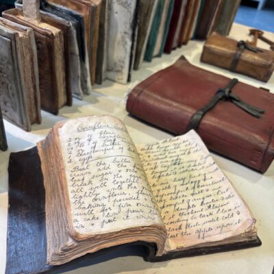 open recipe book and other books - ceramic, paper, pigment and wax - various - by Liz Hanan