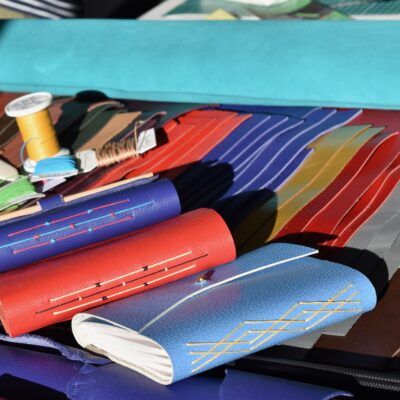 A6 Bindings with pre-cut leathers laid out for a workshop - Leather, paper and thread - A6 books - by Lynne Friel